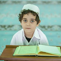 Muslim child reading the Holy Quran